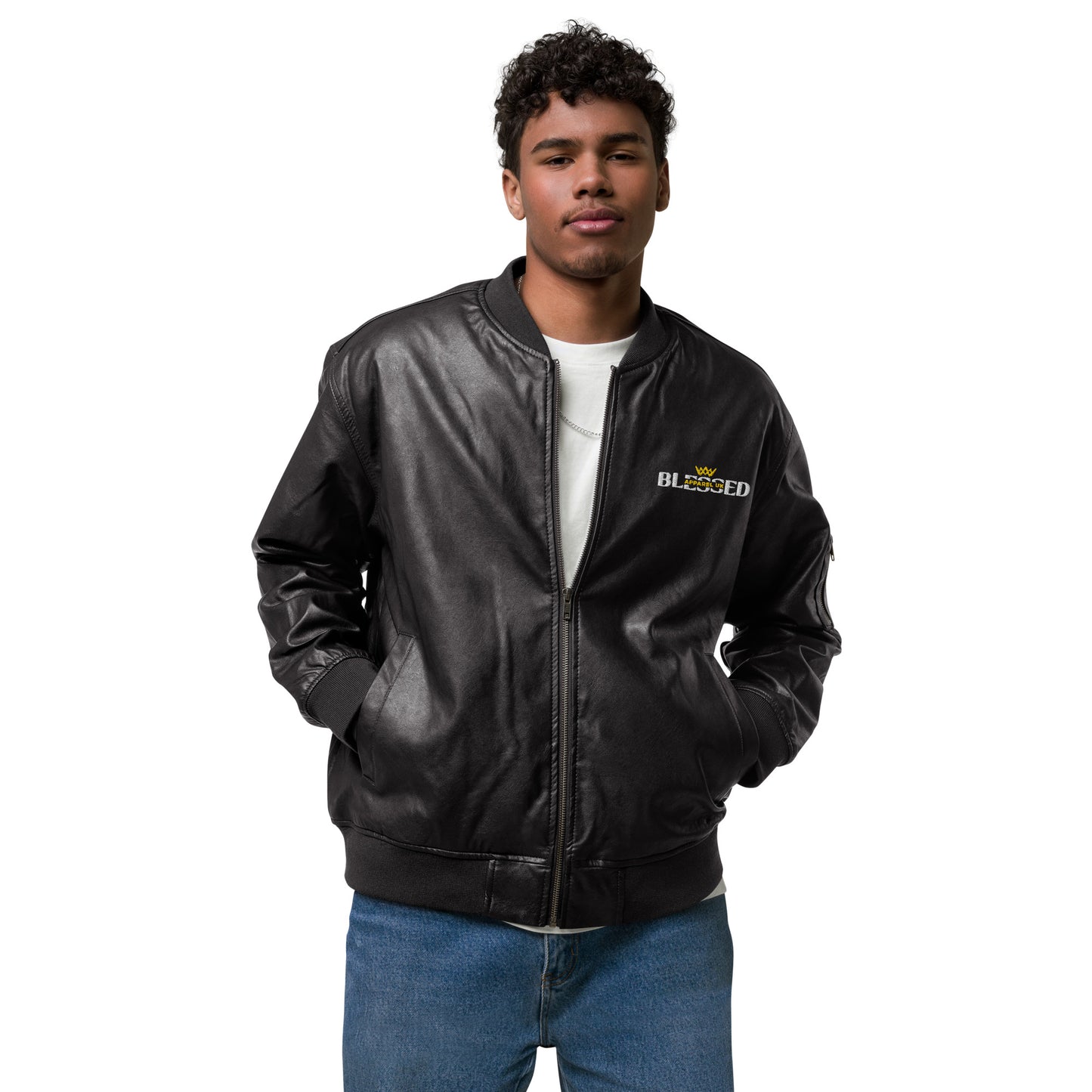 Image of a smiling person wearing a black jacket with hands in pockets, the jacket has blessed apparel logo on the front in yellow and white.