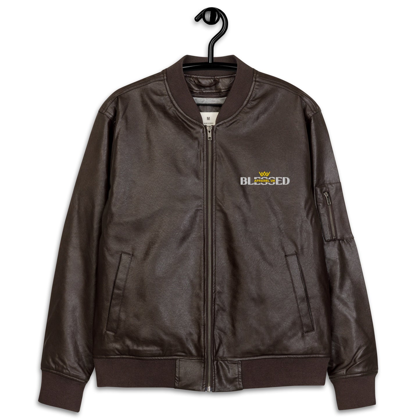 Image of a brown jacket with blessed apparel logo in yellow and white.
