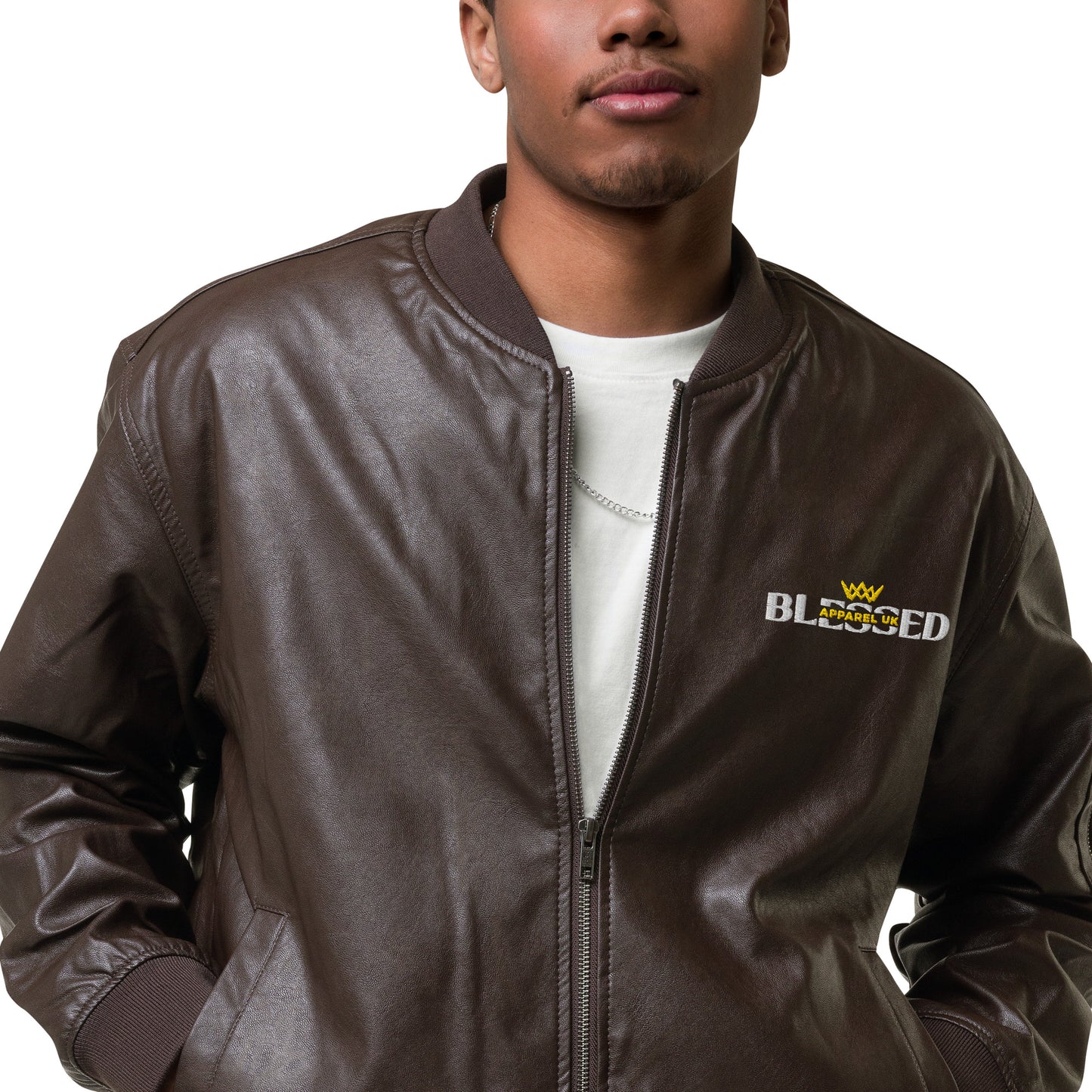 Image of a smiling person wearing a brown jacket with blessed apparel logo in yellow and white.