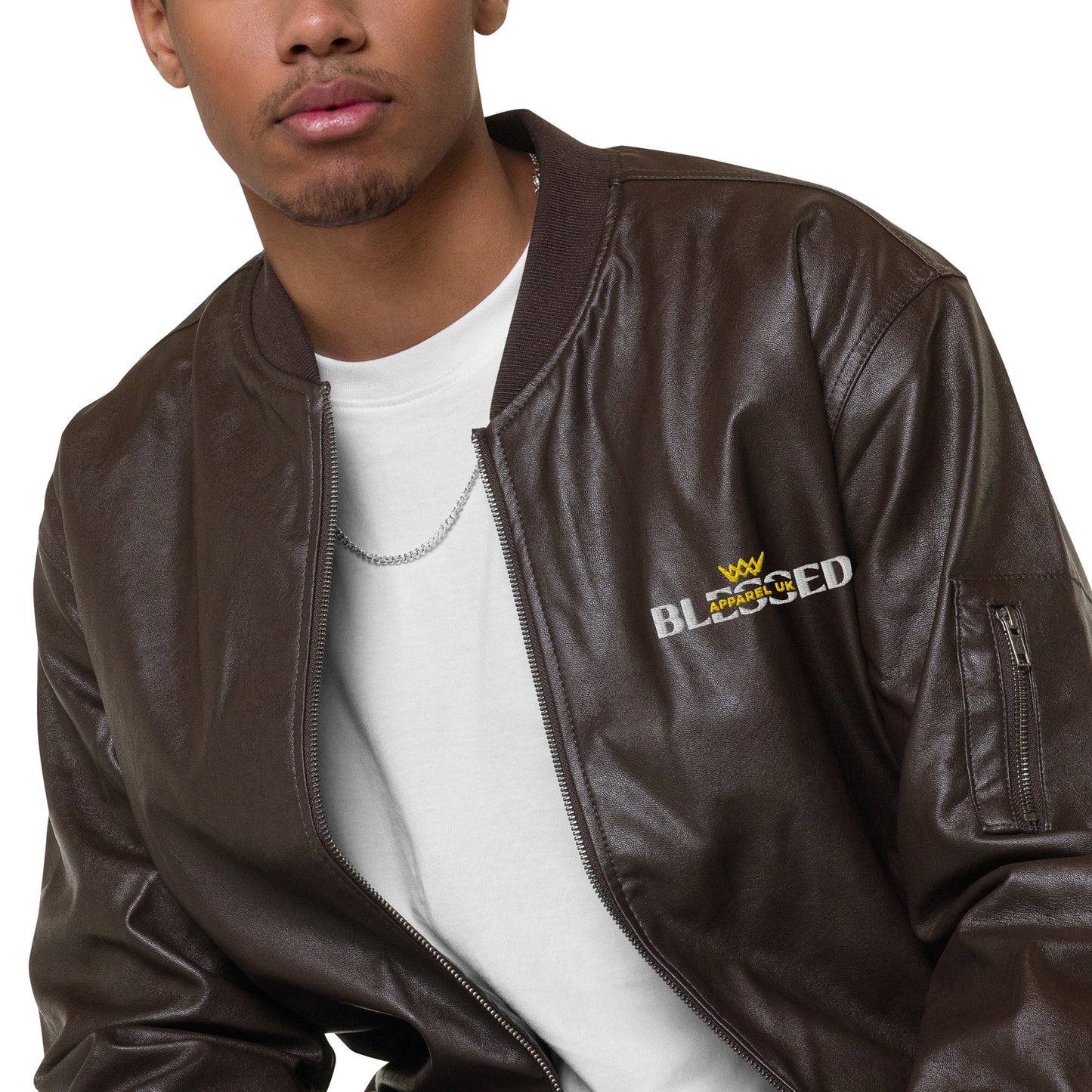 Image of a smiling person wearing a brown jacket with blessed apparel logo in yellow and white.