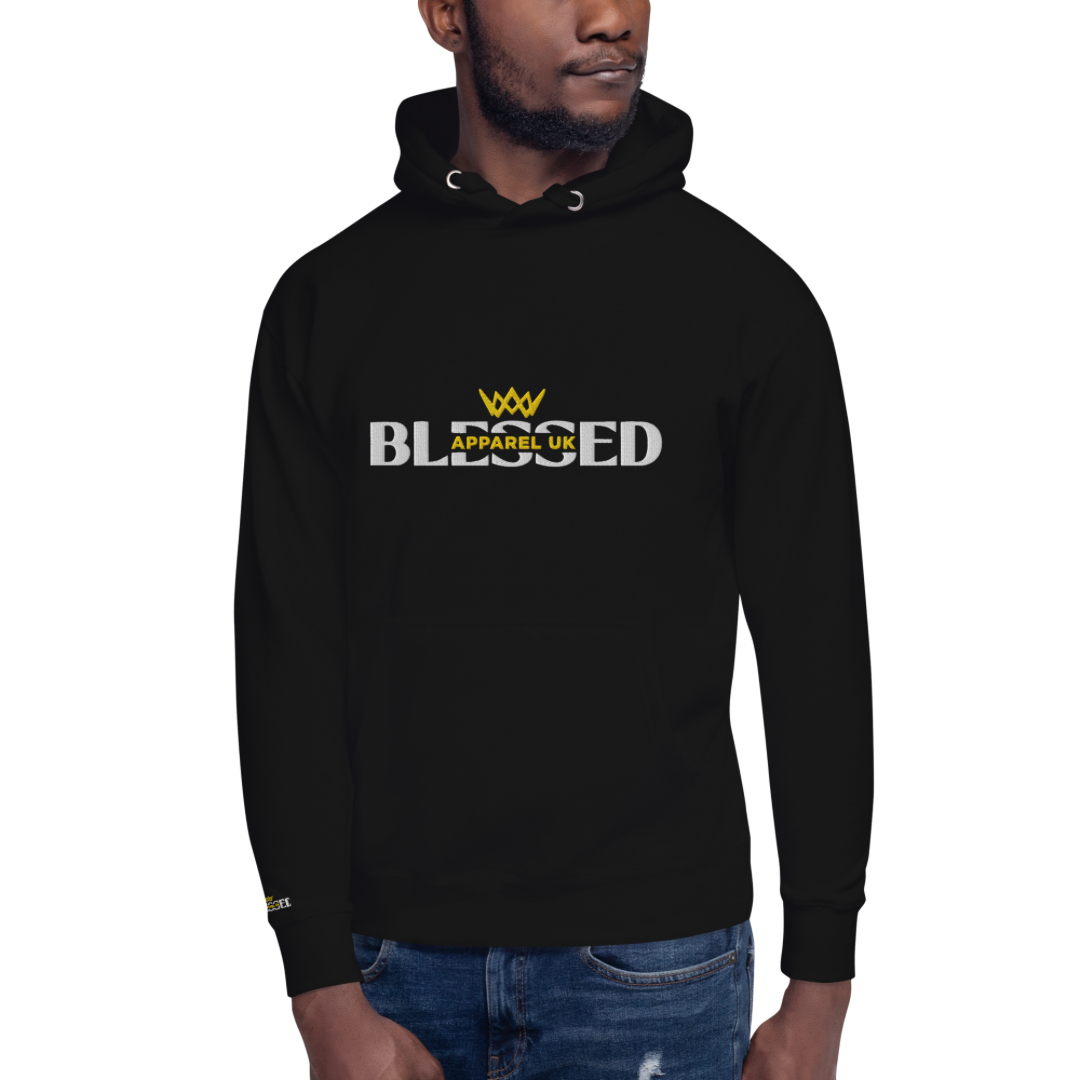 Close up image of a smiling person wearing a black hoodie with blessed apparel logo in yellow and white.