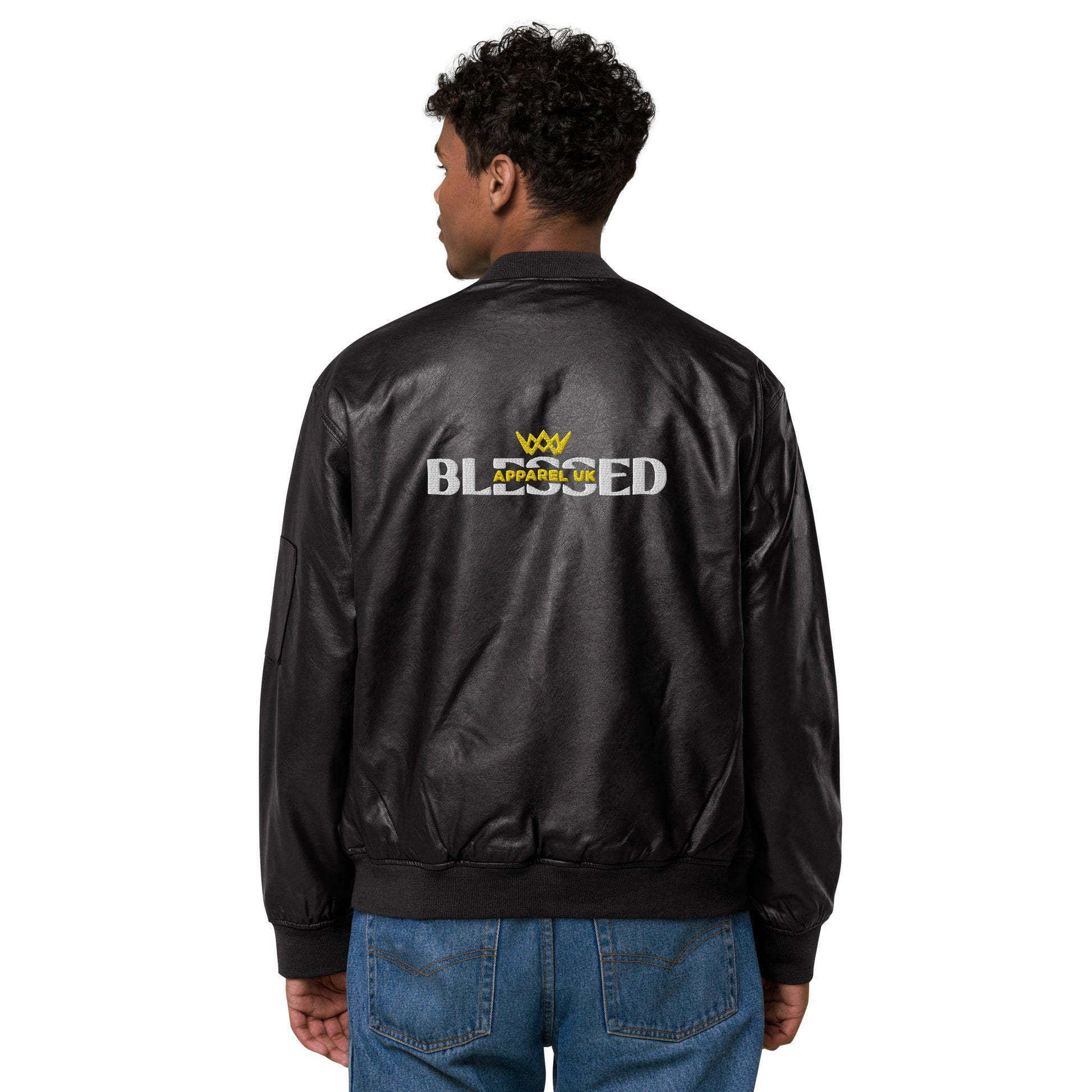 Image of a person standing with their back to the camera, wearing a black jacket with blessed apparel logo in yellow and white.