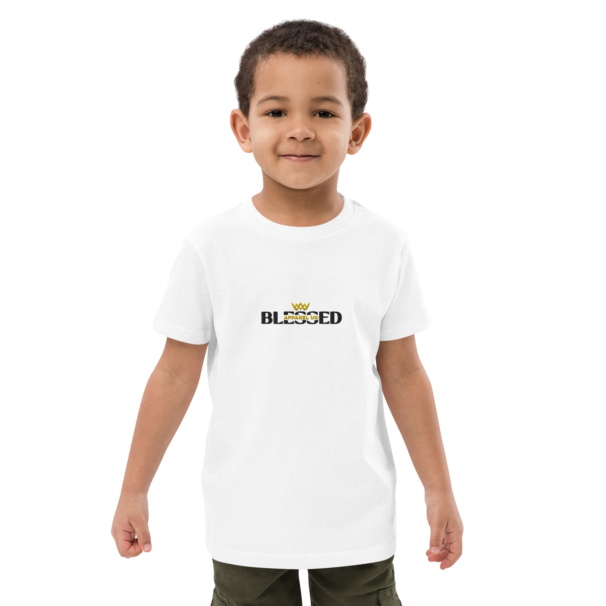 A child wearing a white t-shirt with the Blessed Apparel UK logo in gold and black across the chest.